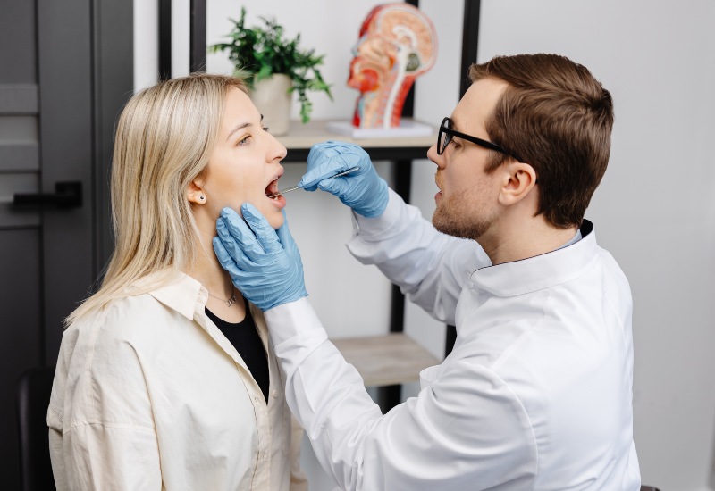 Medical professional examining a patient's gum in Antioch, IL