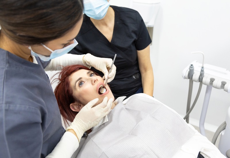 A dentist examining a patient’s oral hygiene at a dental clinic in Antioch, IL