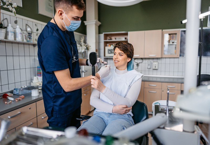 Patient checks smile after dental care in Antioch, IL
