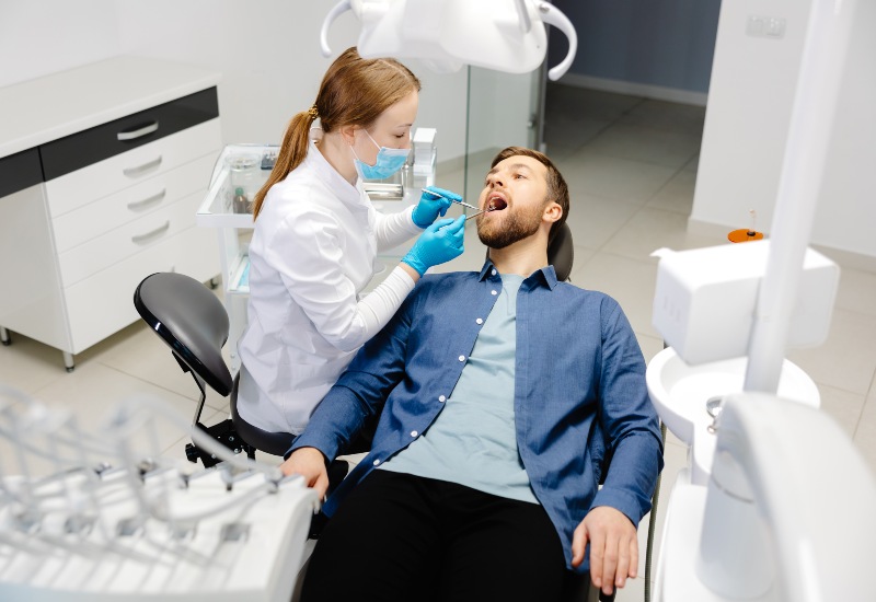 Dentist examining patient during checkup in Antioch, IL