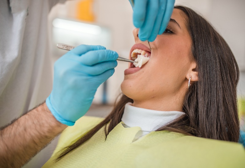 Dentist performing tooth extraction treatment in Antioch, IL